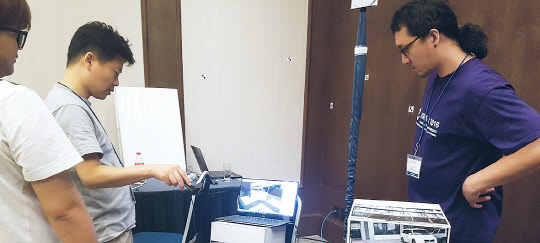 지난달 멕시코 메리다시에서 개최된 'IEEE 증강현실 국제심포지엄 2016' 국제기술경연대회에서 ETRI 연구팀이 3차원 카메라 추적기술 기반의 증강현실 기술을 시연하고 있다.   ETRI 제공